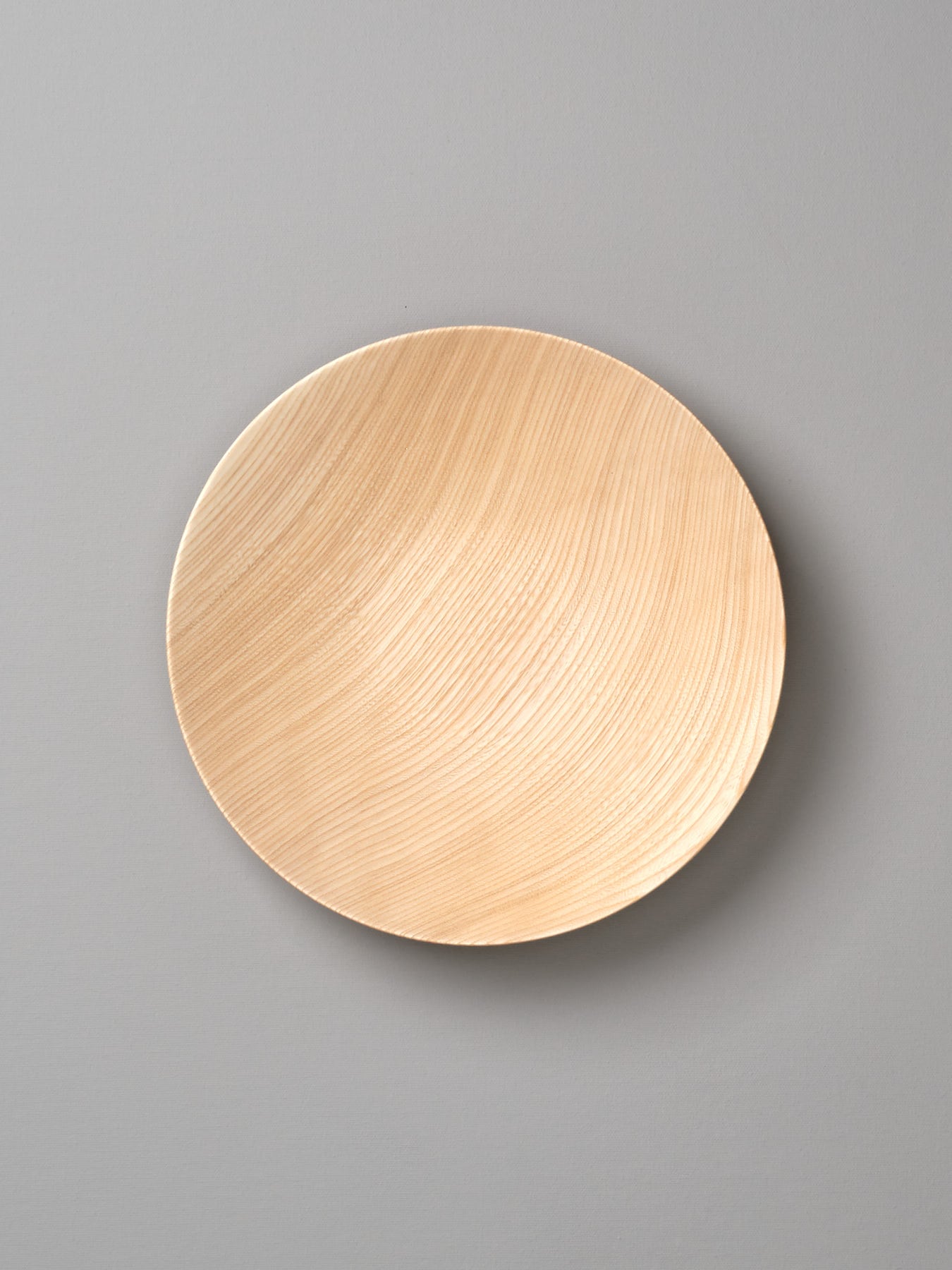 A Kihachi Wooden Plate - Medium on a gray background.
