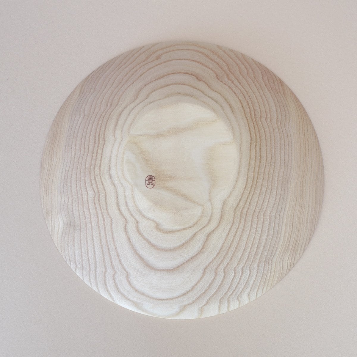 A Kihachi Wooden Plate - Medium on a white surface.