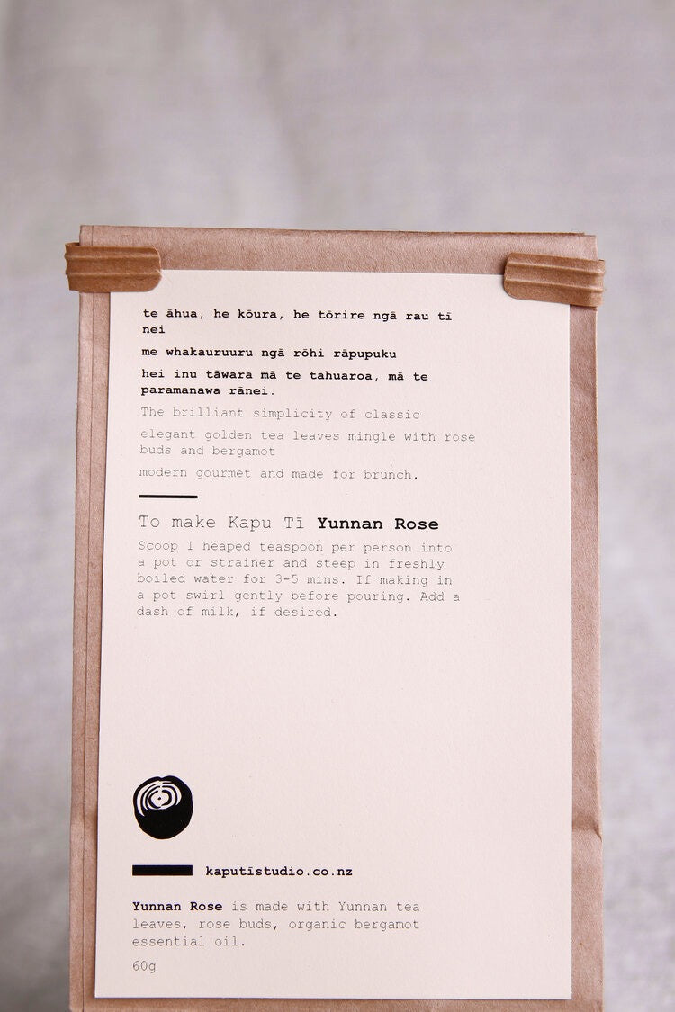 A Yunnan Rose brown paper bag with a note on it from Kaputi Studio.