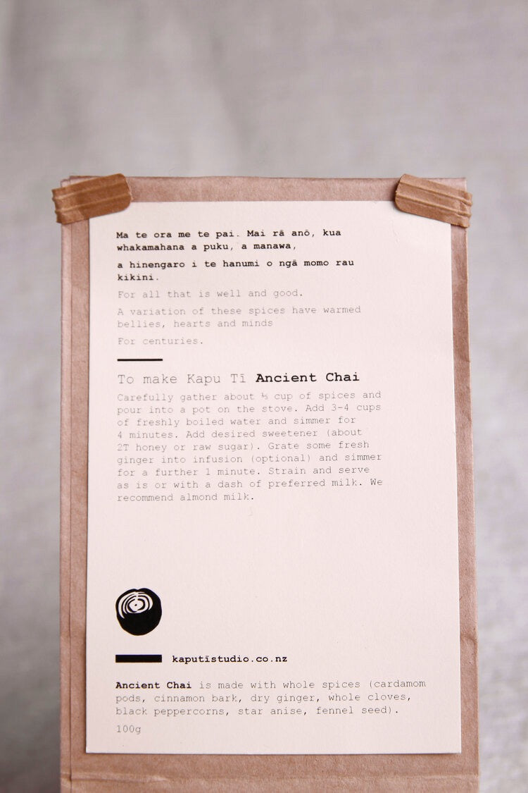 A brown paper bag with a note on it containing Ancient Chai from Kaputi Studio.