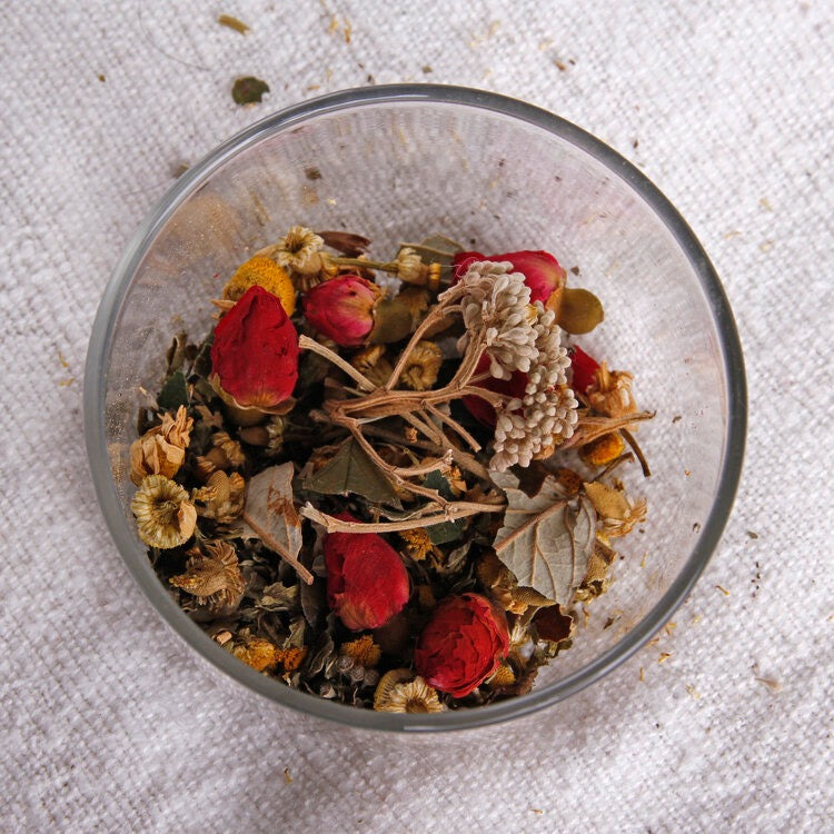 A glass bowl filled with Kūmarahou Calm dried flowers and herbs by Kaputi Studio.