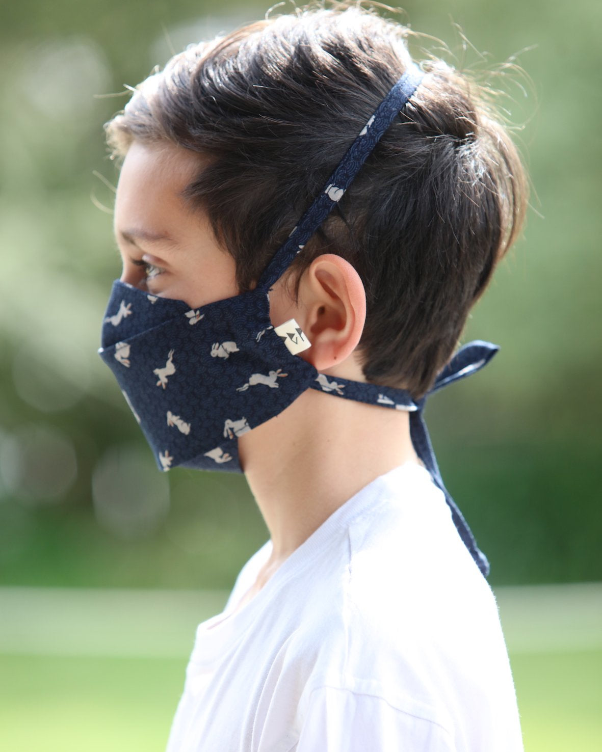 A young boy wearing a Peppin Kids Face Mask - Japanese Print.