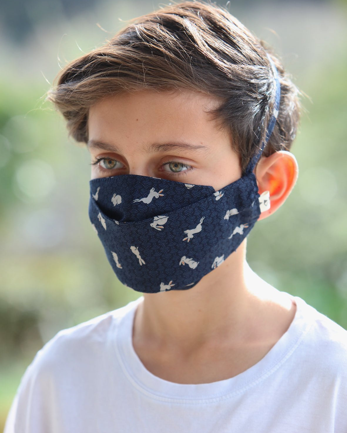 A young boy wearing a Peppin Kids Face Mask - Japanese Print.