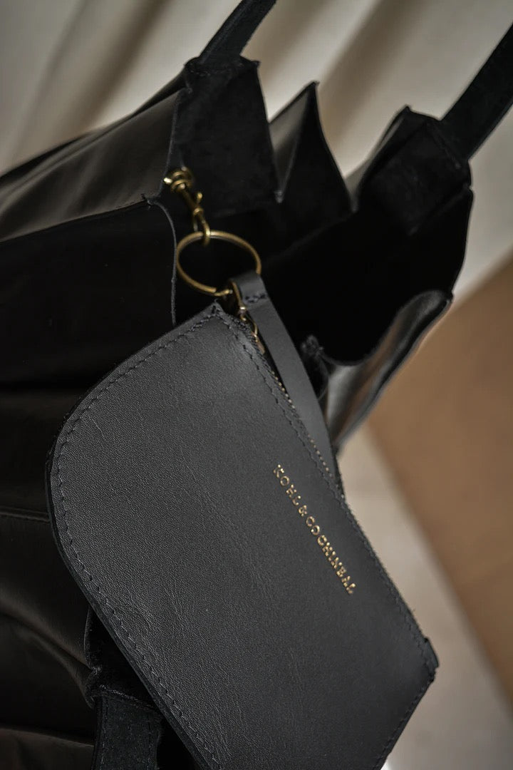 A Pleats black tote bag with a key ring attached to it. (Brand: Kohl &amp; Co)