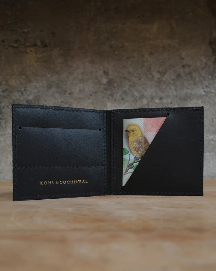 A black leather wallet with a picture of a bird on it, called The Skinny Wallet by Kohl & Co.
