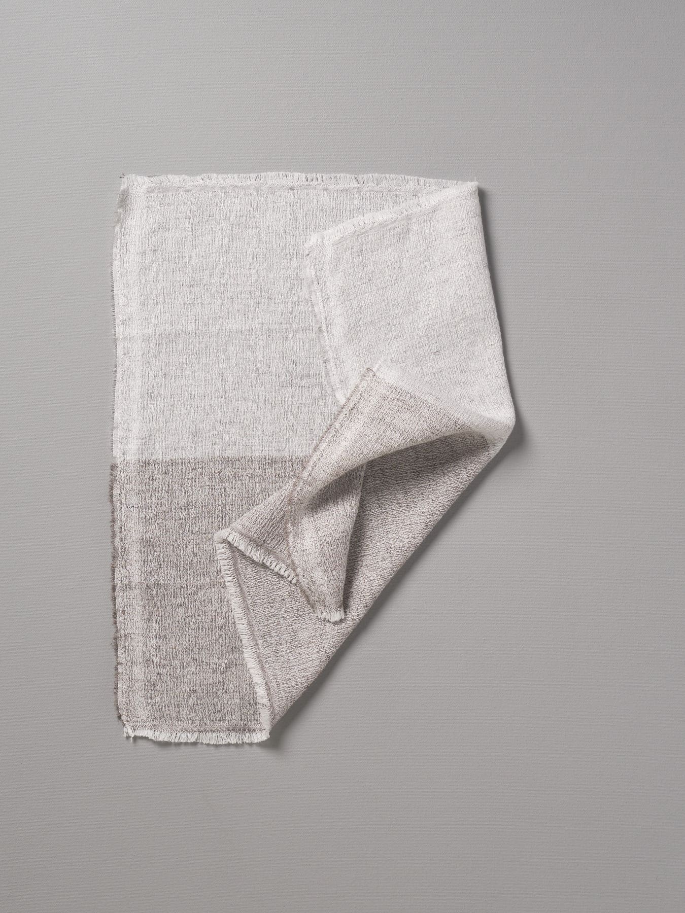 A folded Kontex Shukin Towel in Two Tone Grey ⋄ Pink color block design, displayed on a neutral background.