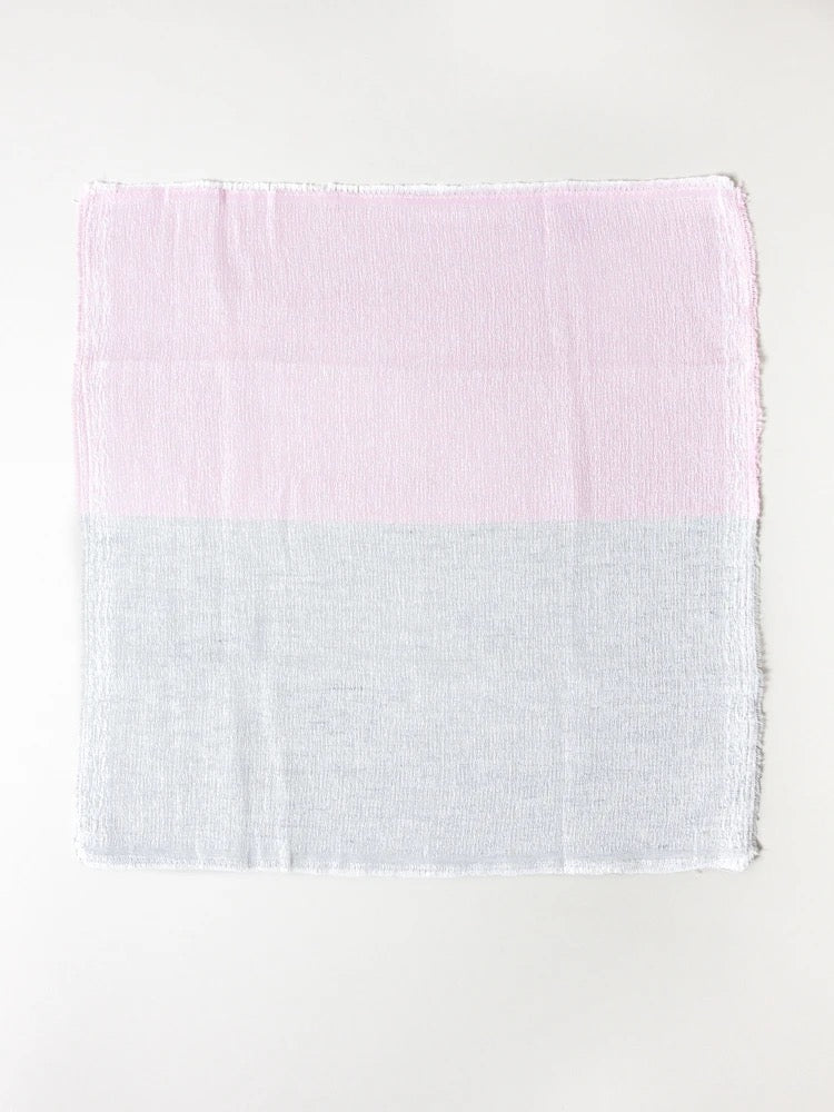 A highly absorbent Shukin Towel - Two Tone Grey ⋄ Pink, made in Imabari by Kontex, on a white background.