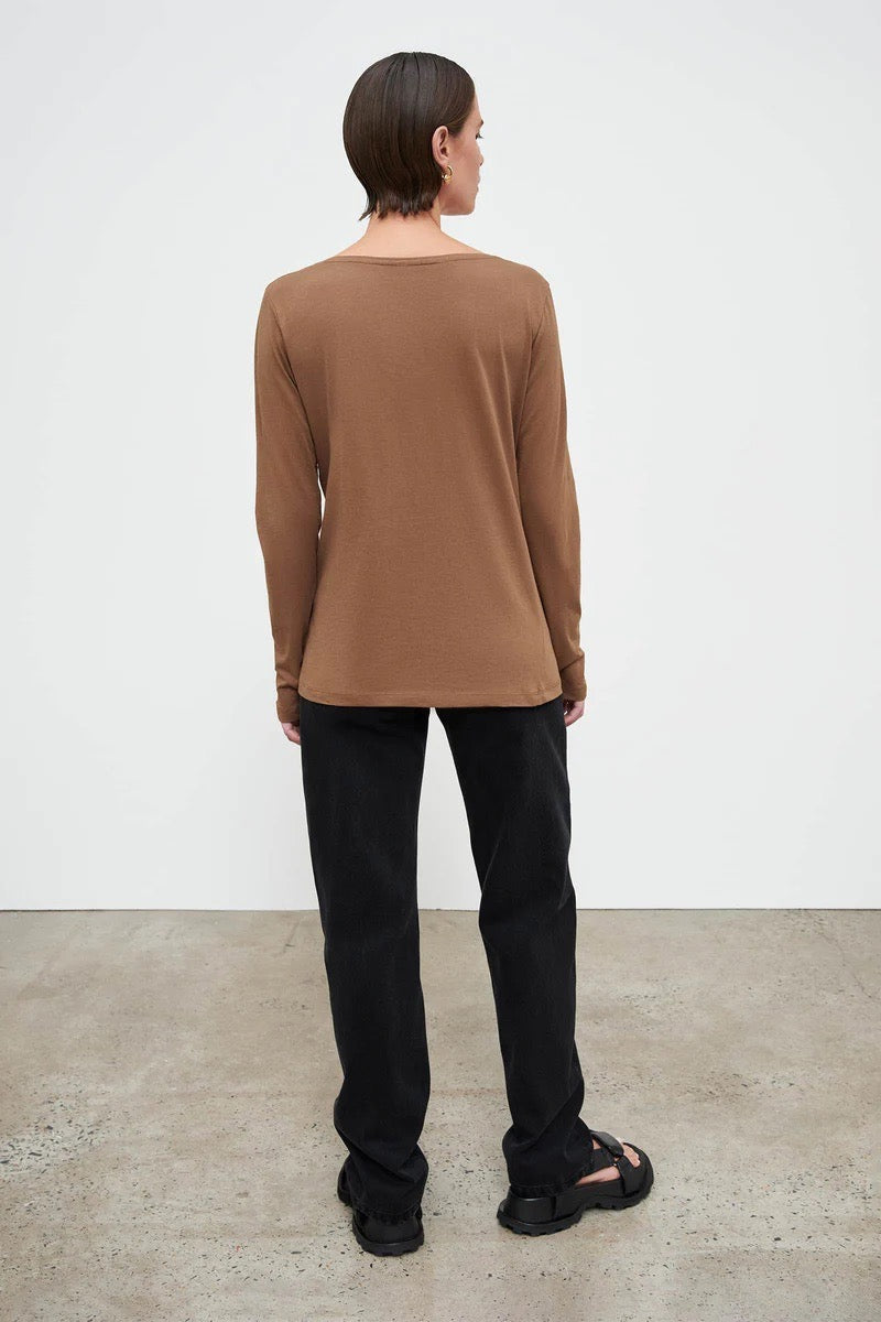 The back view of a woman wearing a Kowtow Ballet Top - Earth.