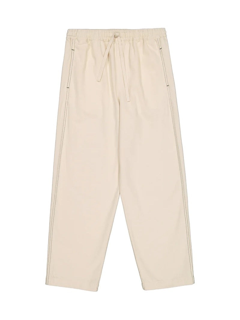 A pair of Blake Pants - Greige by Kowtow with zippers on the side.