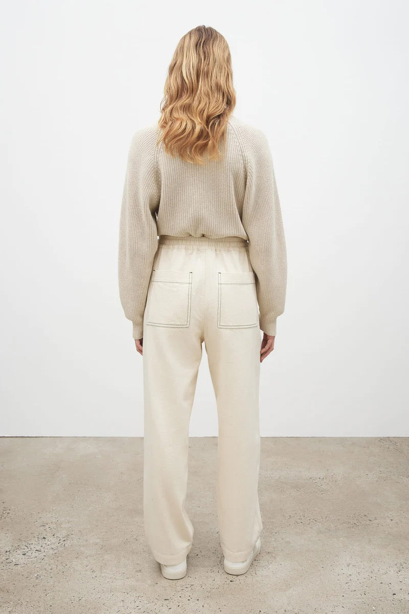 The back view of a woman wearing Kowtow&#39;s Blake Pants – Greige and a white sweater.