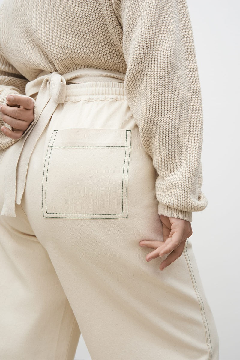 The back of a woman wearing Kowtow&#39;s Blake Pants – Greige and a sweater.