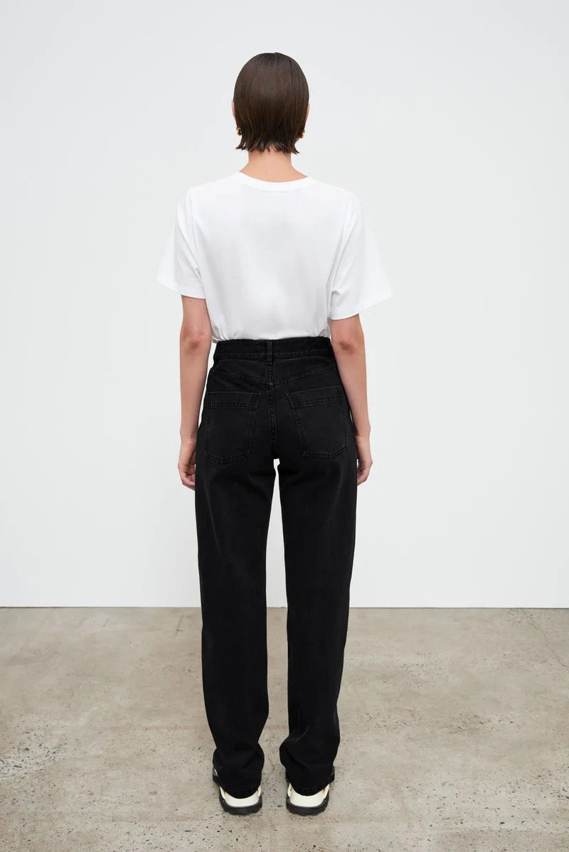 The back view of a woman wearing Kowtow Classic Jeans – Black Denim.