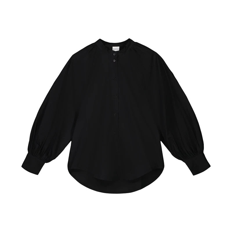 A Kowtow Ella Shirt - Black with puff sleeves.