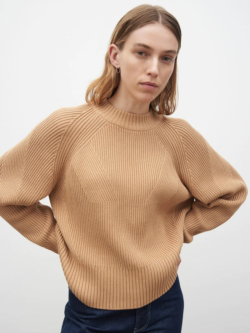 The model is wearing a Kowtow Henri Crew - Beige sweater.