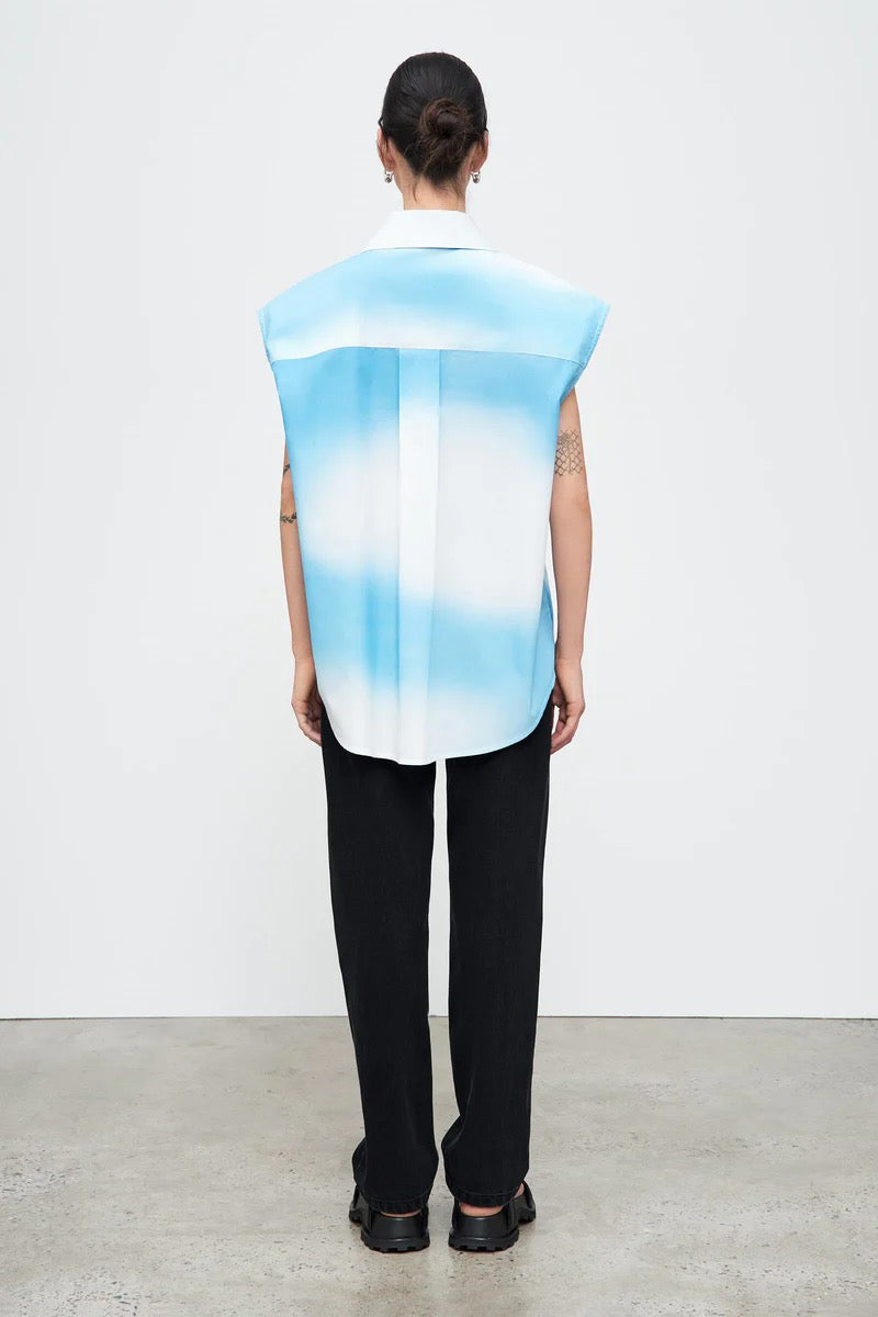 The back view of a woman wearing a Kowtow Play Top - Cloud shirt.