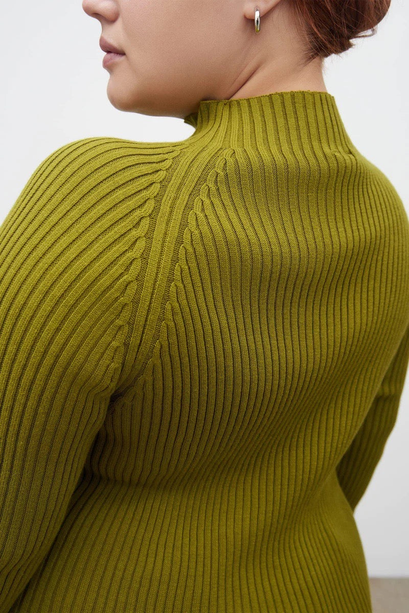 The back of a woman wearing a Kowtow Row Top - Lawn ribbed sweater.