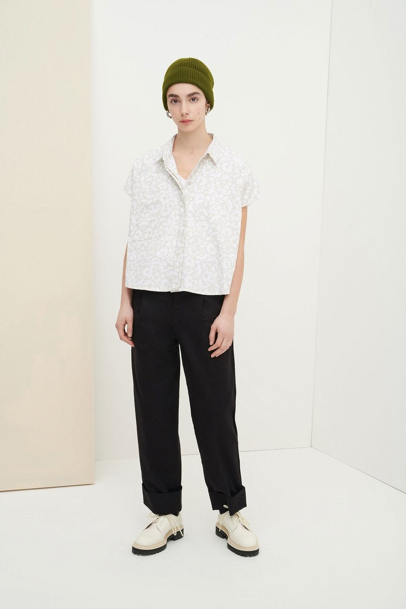 A model wearing the Kowtow Studio Shirt - Flora Print and black pants.