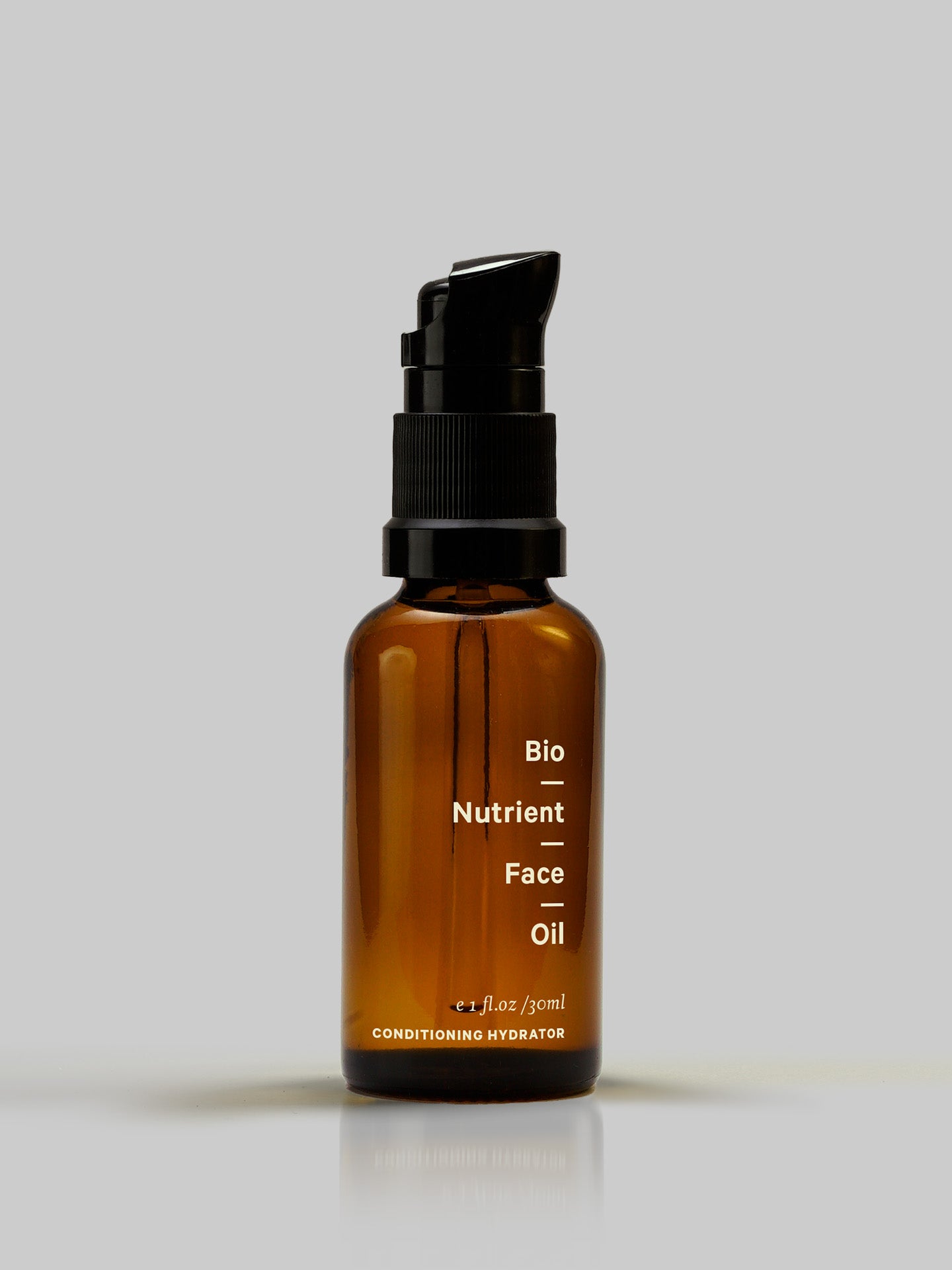 A bottle of MARYSE Bio Nutrient – Face Oil on a grey background.