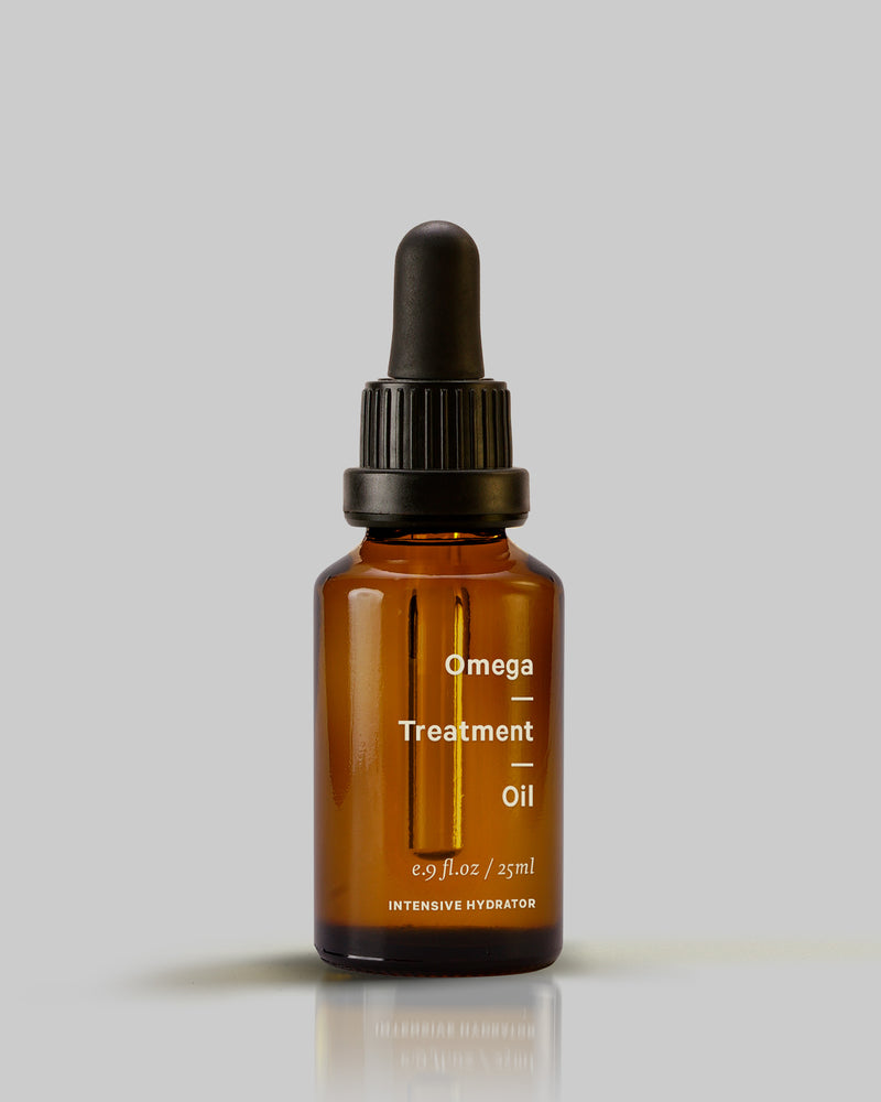 A bottle of MARYSE Omega – Treatment Oil on a grey background.