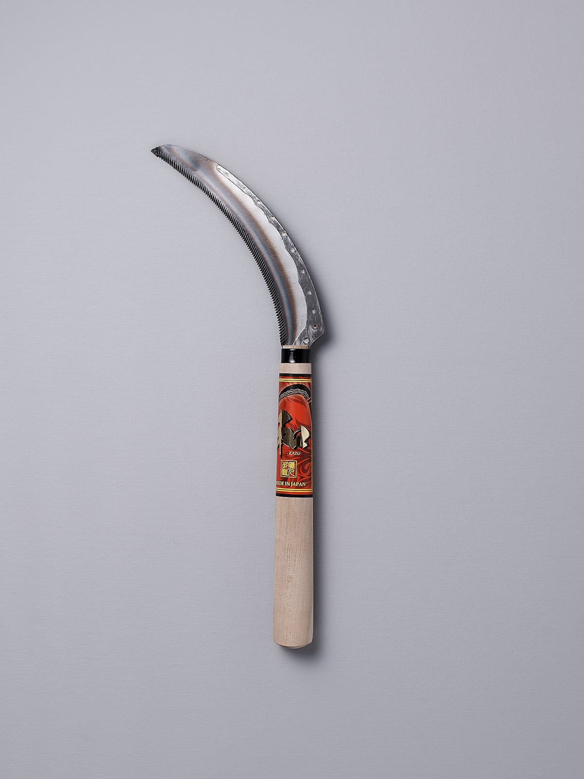 A Flax Cutter with a wooden handle on a gray background. (Maruyoshi)