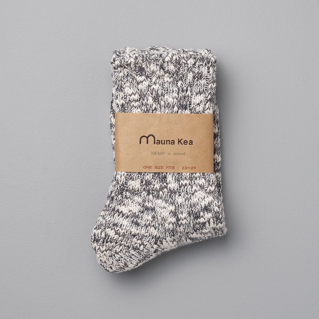 A pair of Mauna Kea Japanese Slub Socks – Grey with a label on them.