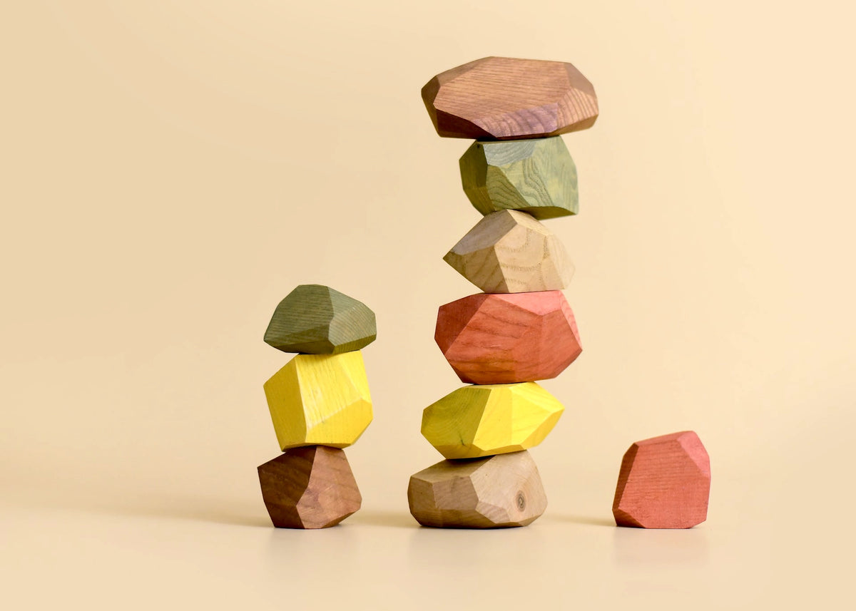 A stack of Balancing Stones - Earthy by MinMin Copenhagen on a beige background.