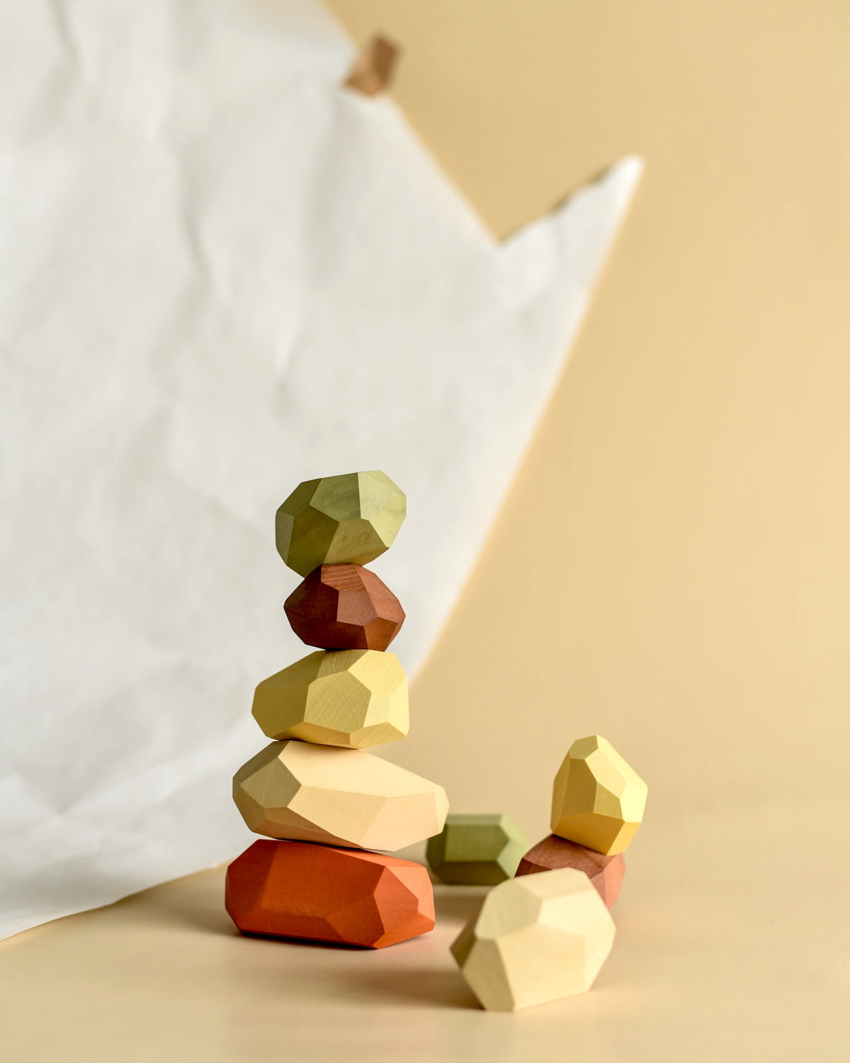 A stack of Balancing Stones - Earthy by MinMin Copenhagen next to a piece of paper.