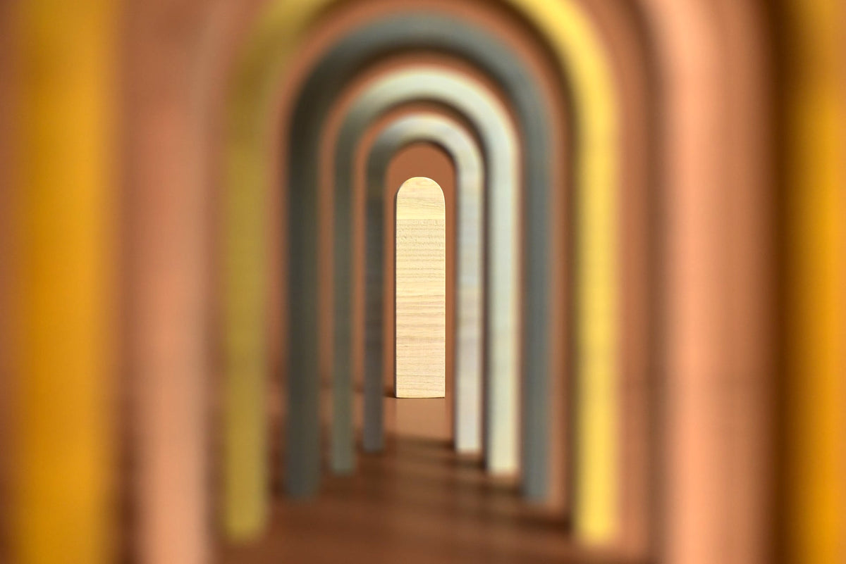 A blurry image of a Big Rainbow - Pastel hallway with colored arches by MinMin Copenhagen.