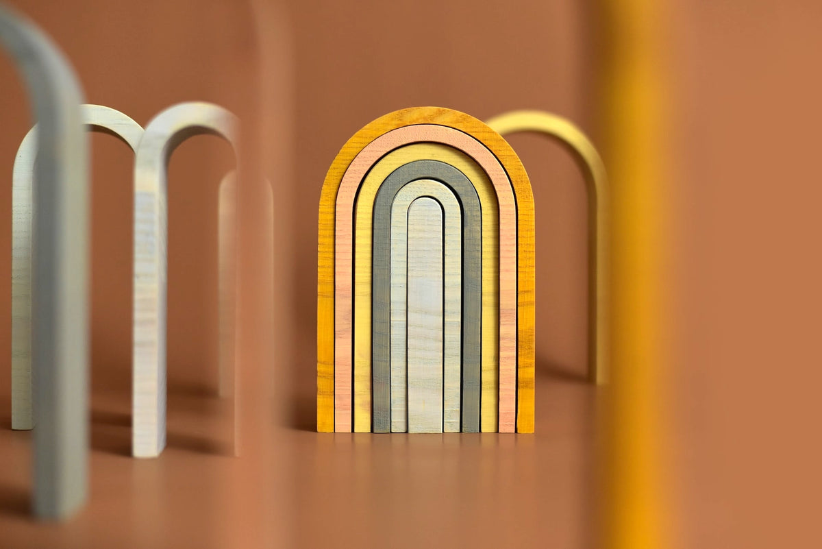 A set of Big Rainbow - Pastel wooden blocks with a rainbow in the middle by MinMin Copenhagen.