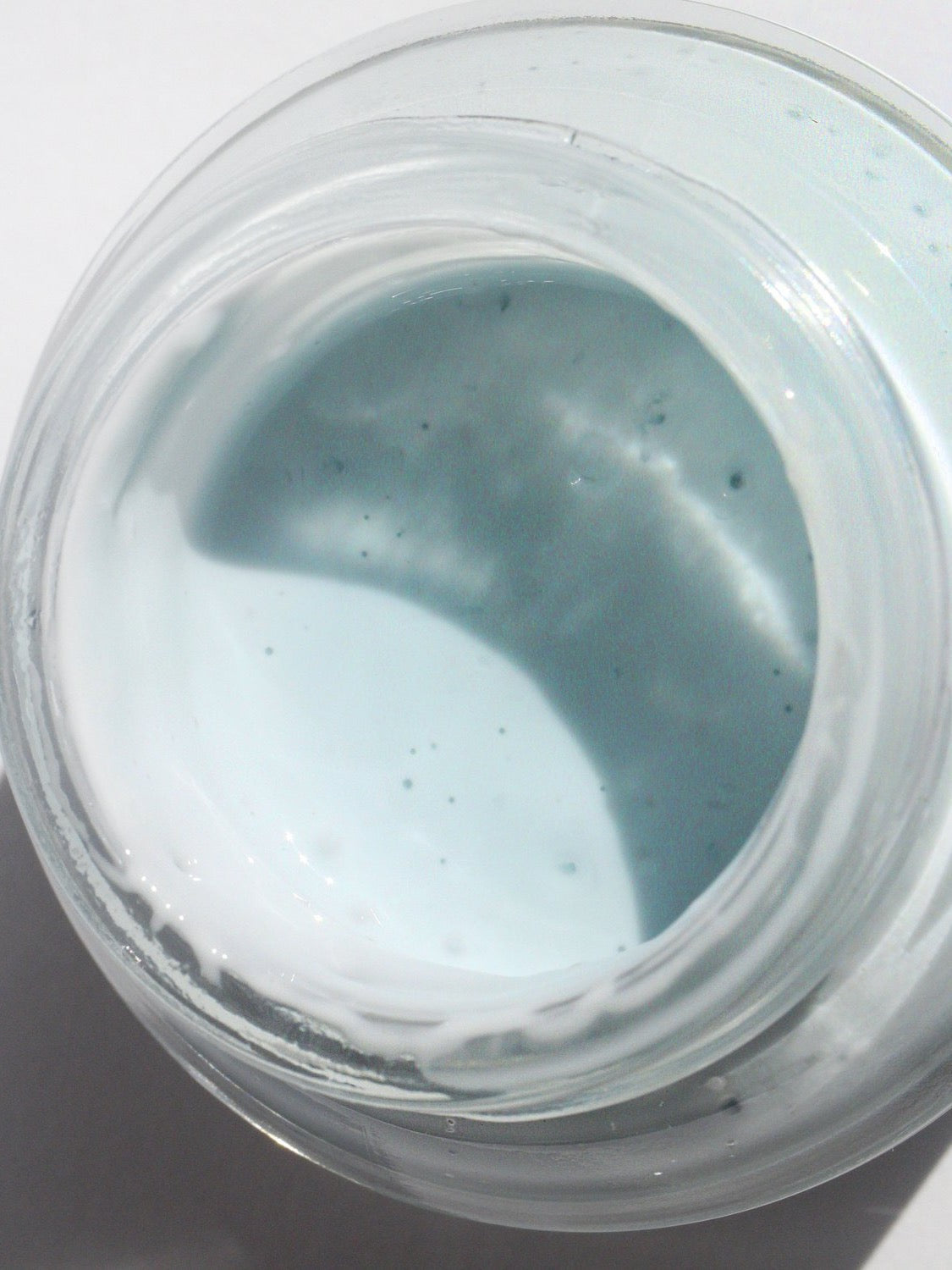 A jar of NOTO Moisture Riser Cream sitting on top of a white surface.