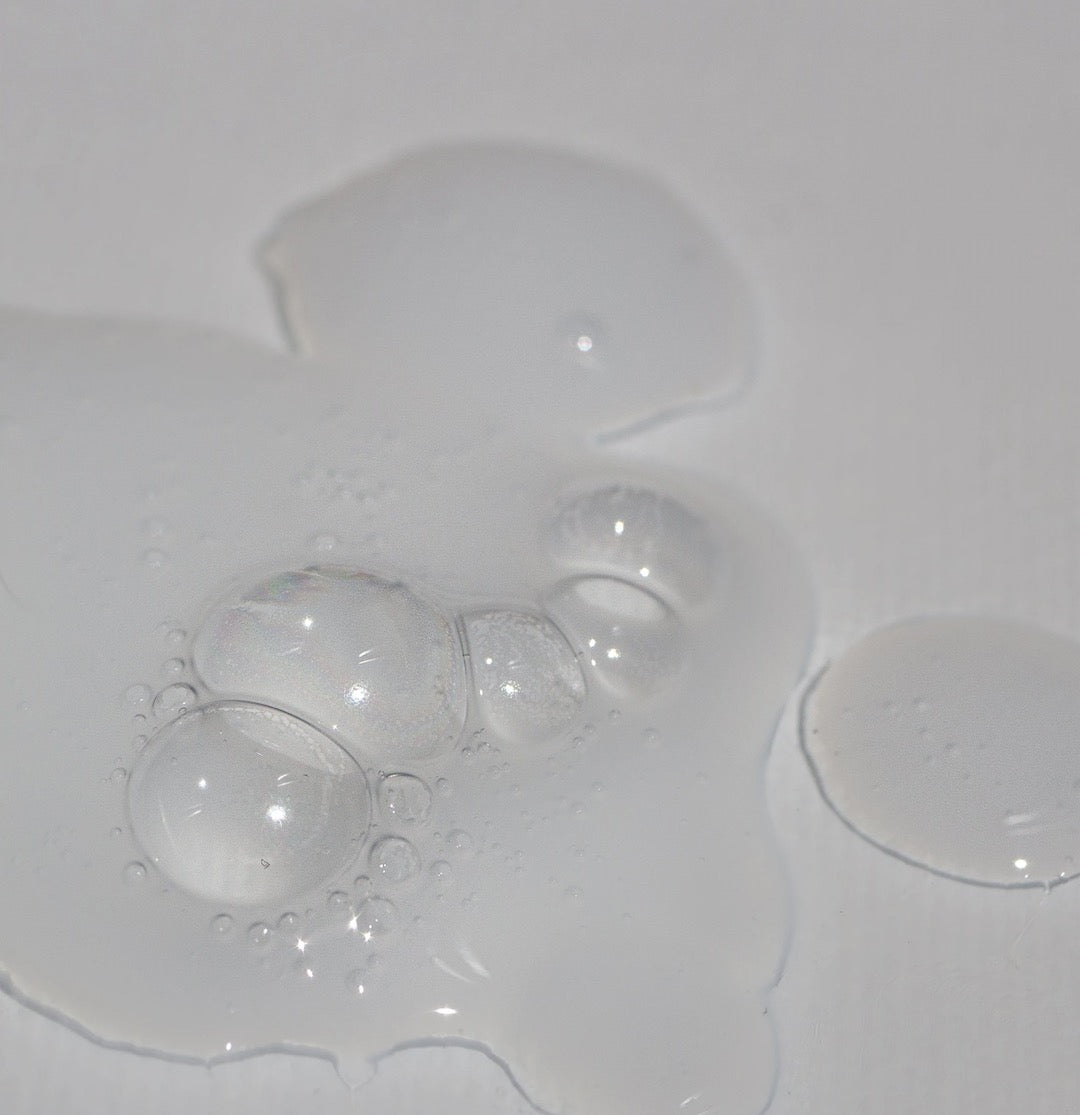 The NOTO Wash droplets on a white surface.