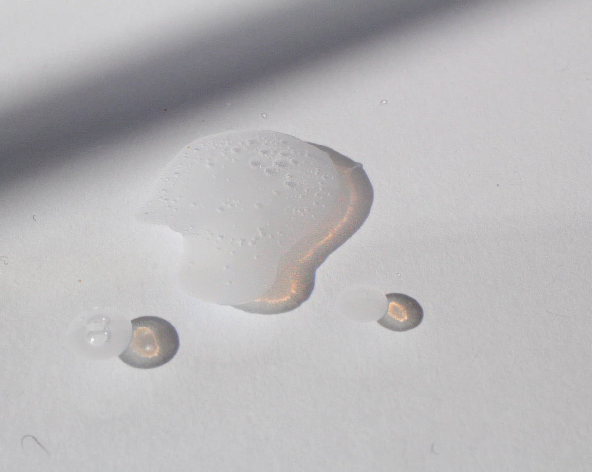 A drop of The Wash by NOTO on a white surface.