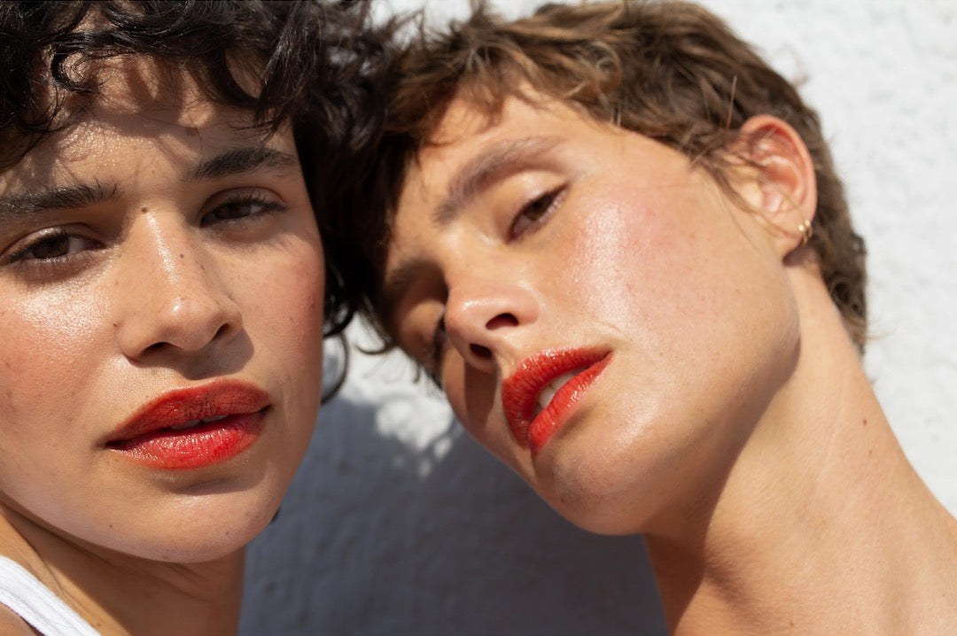 Two women are posing with NOTO&#39;s Oscillate – Multi-Bene Stain Stick // Lips + Cheeks on their lips.