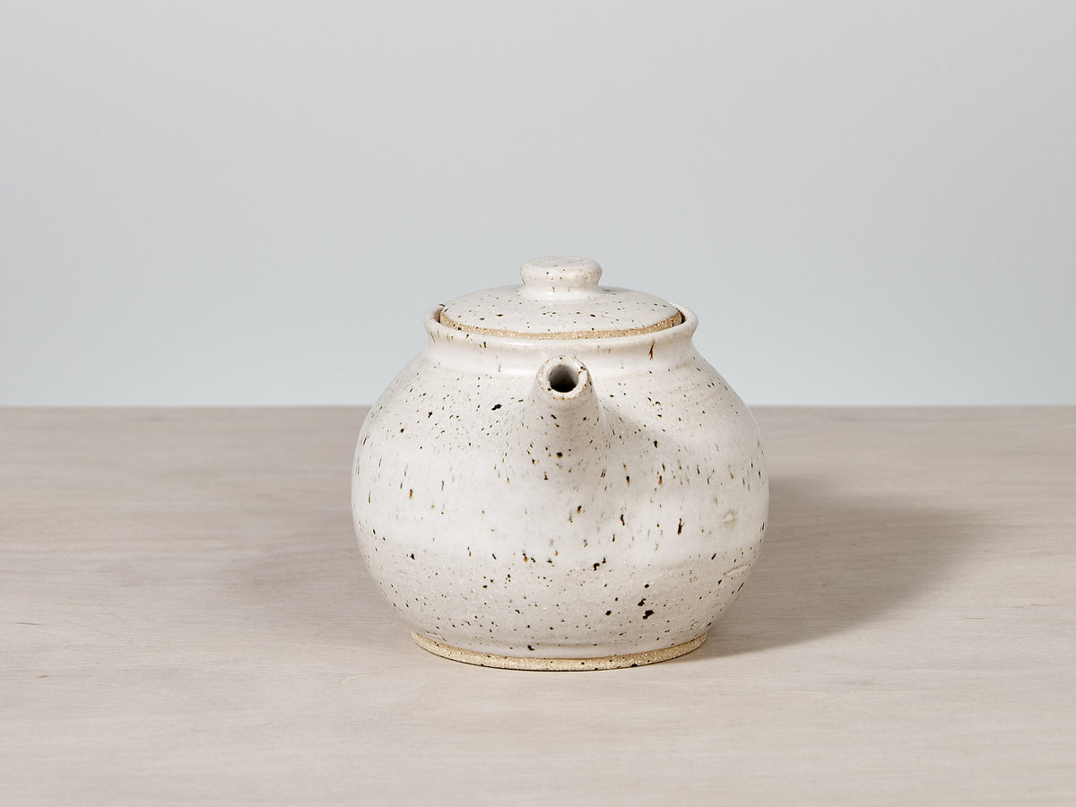 A &quot;Tea Pot – Speckled&quot; by Nicola Shuttleworth on a wooden table.