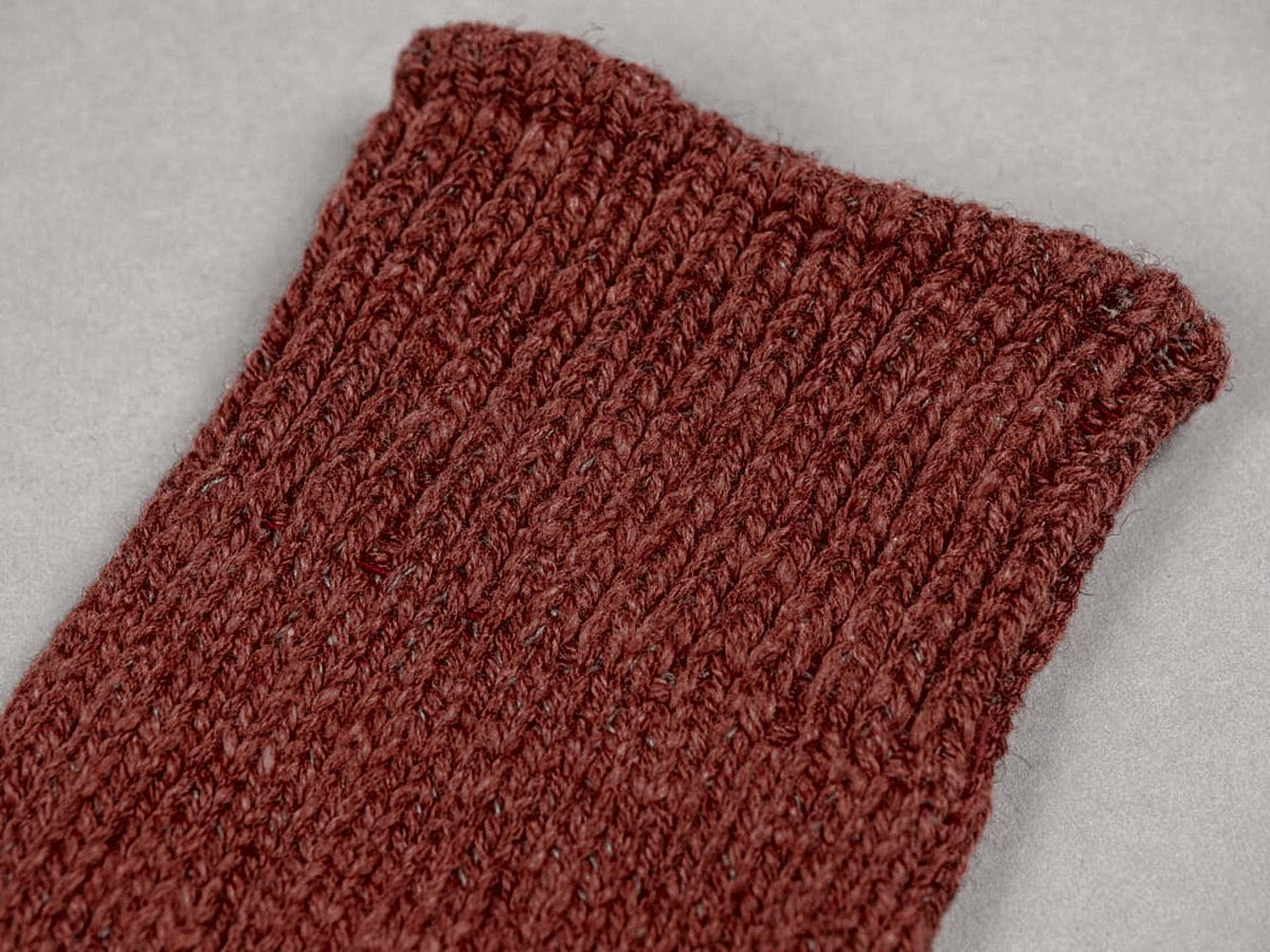 A close up of a red Boston Slab Socks – Red Brick knitted sock from Nishiguchi Kutsushita.