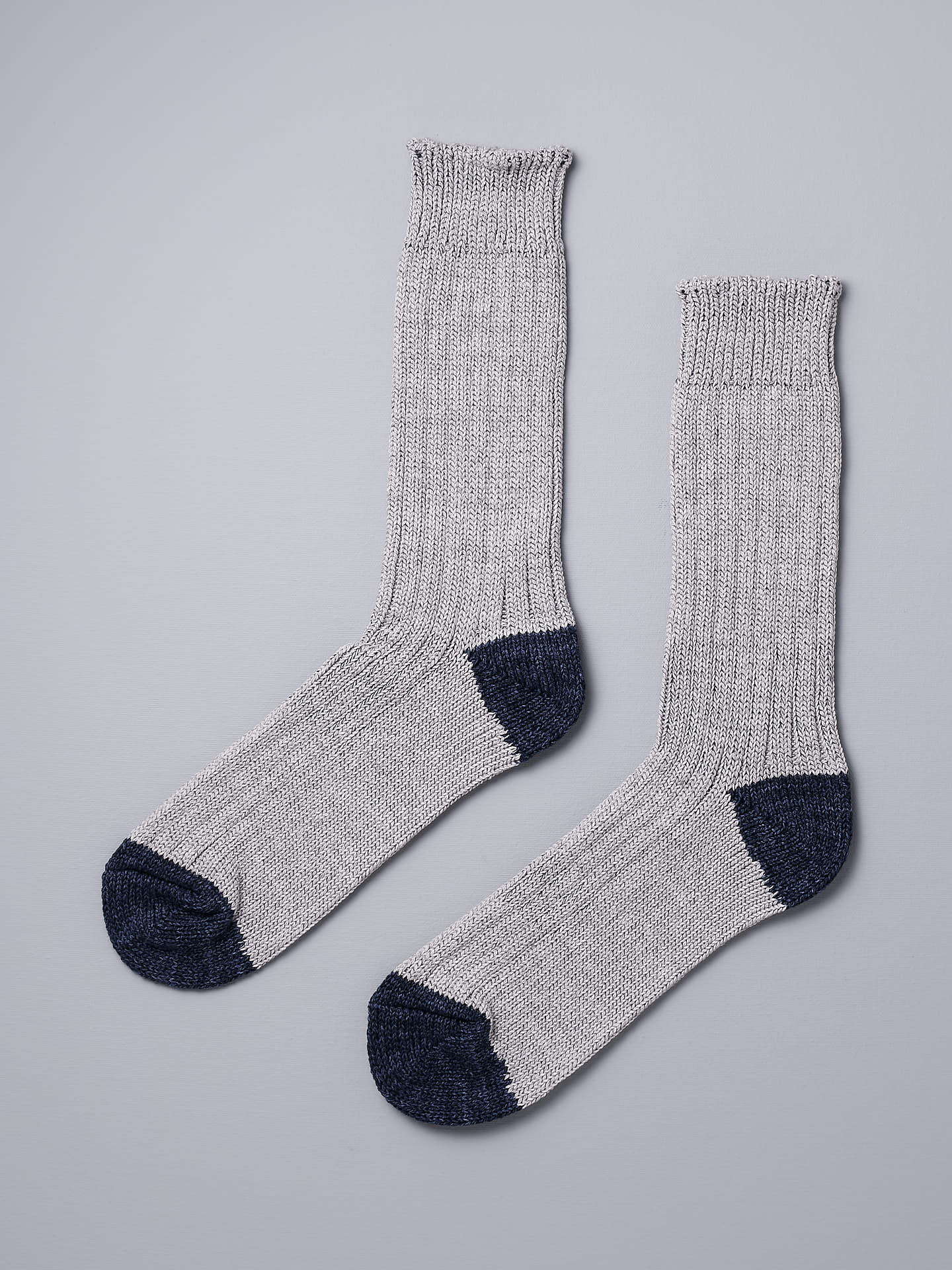 A pair of Boston Slab Socks – Grey Denim by Nishiguchi Kutsushita on a white background.