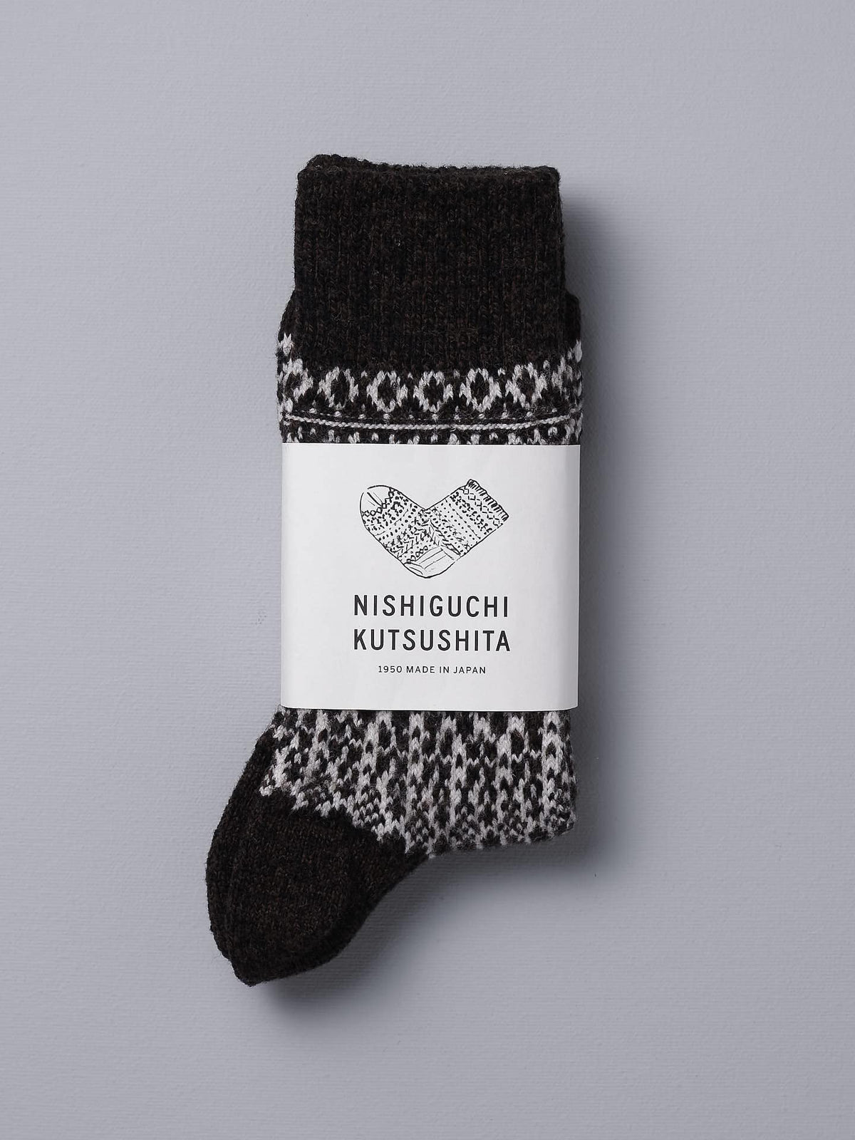 A Nishiguchi Kutsushita Oslo Wool Jacquard Socks – Coffee with a black and white pattern.