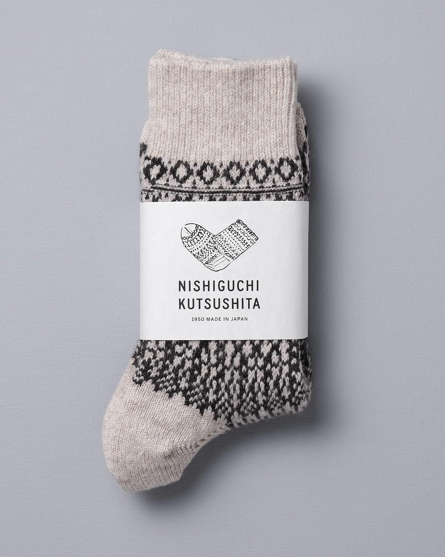 A pair of Nishiguchi Kutsushita Oslo Wool Jacquard Socks – Oatmeal, sized for EUR or US Men's & Women's, laid flat on a gray surface.