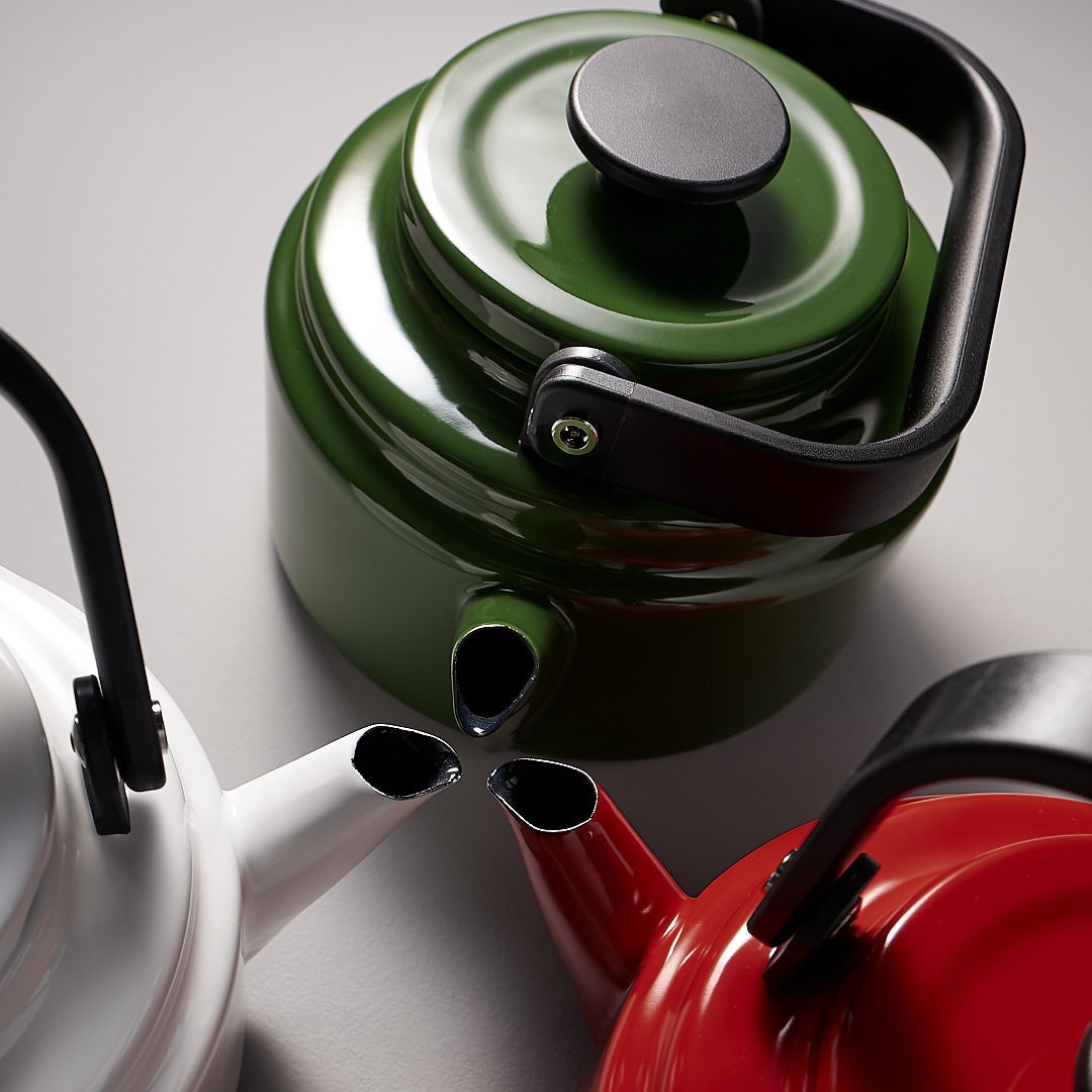 Three Amu Stove-top Kettles – Red by Noda Horo on a white surface.
