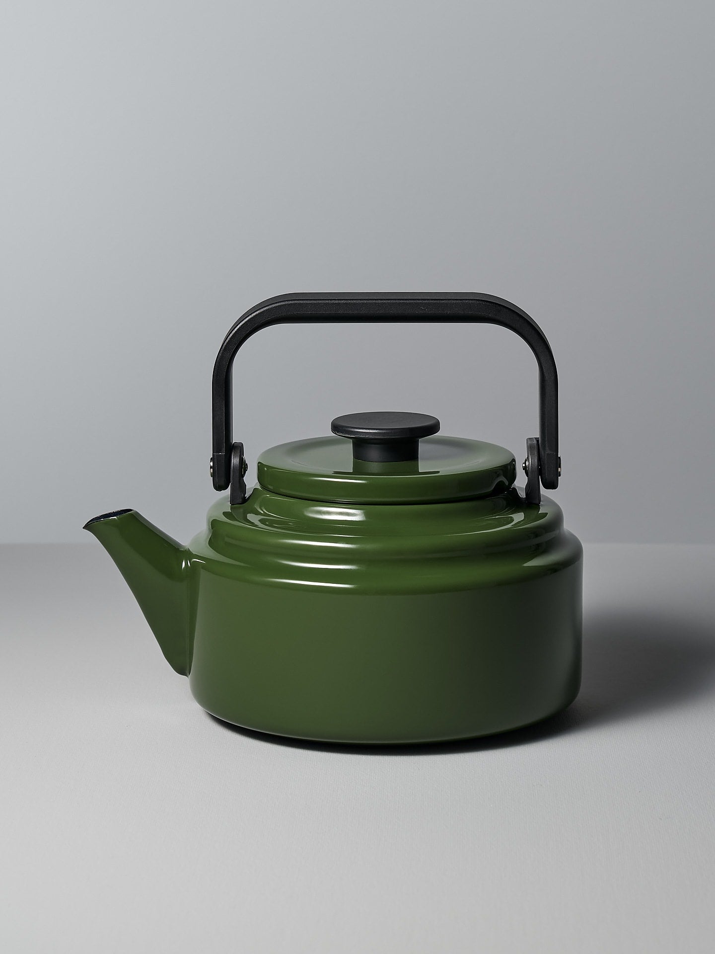 An Amu Stove-top Kettle - Green by Noda Horo on a grey background.