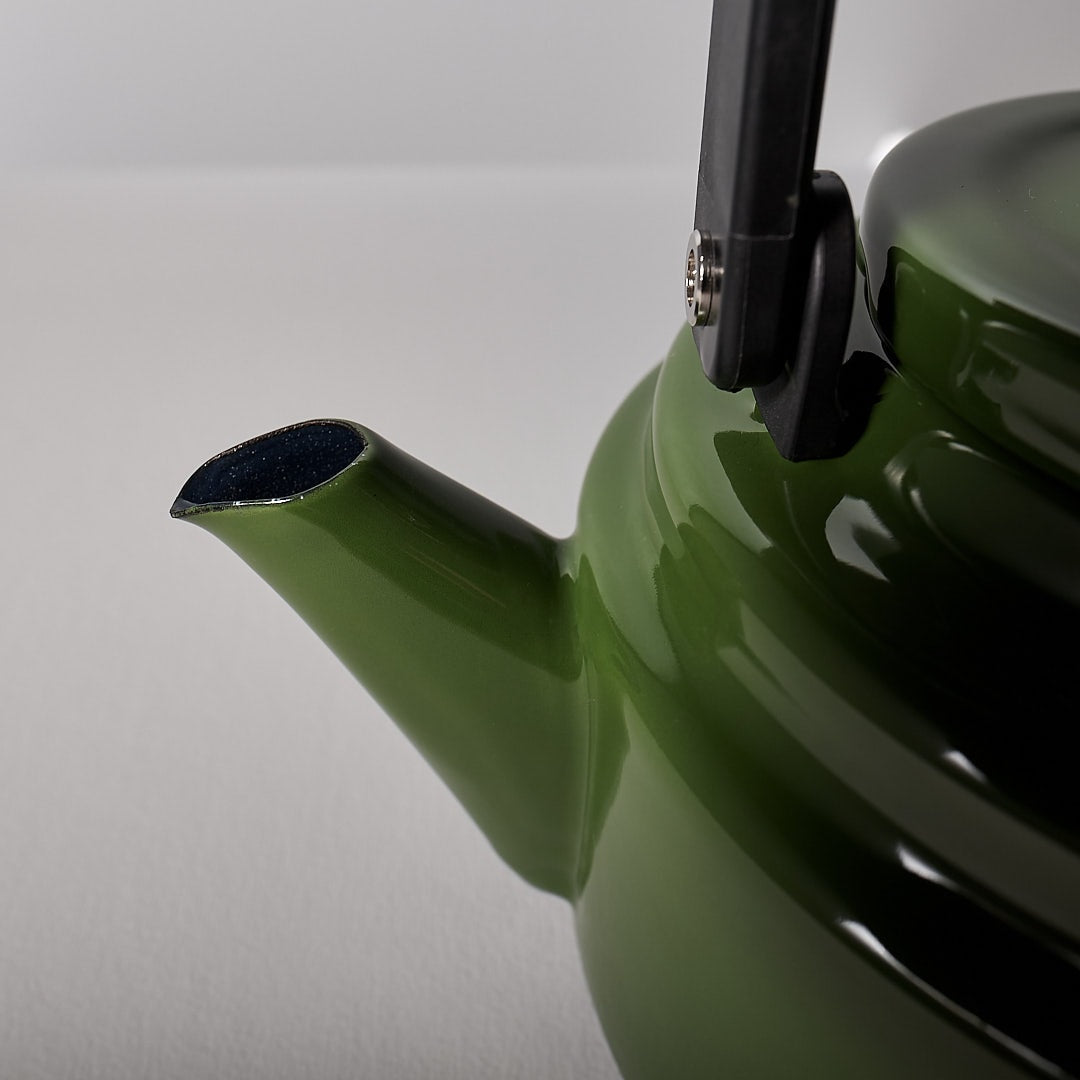 An Amu Stove-top Kettle - Green with a black handle. (Brand: Noda Horo)