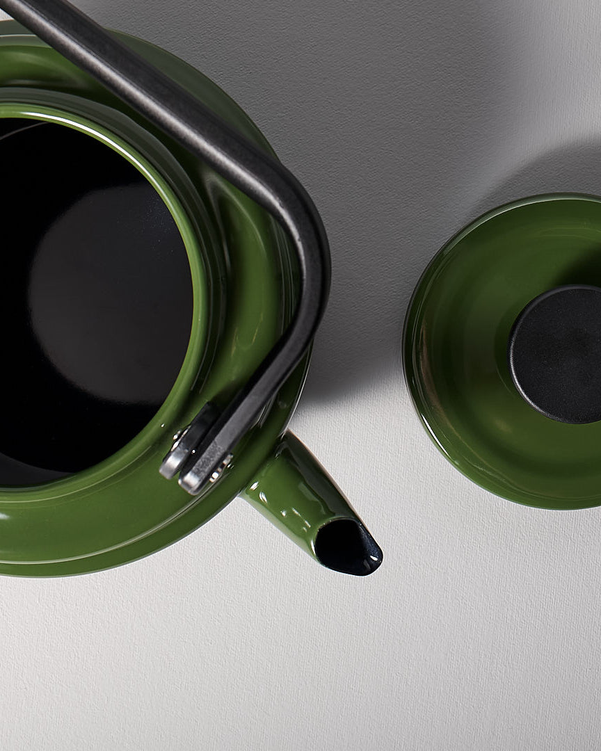An Amu Stove-top Kettle - Green by Noda Horo on a grey background.