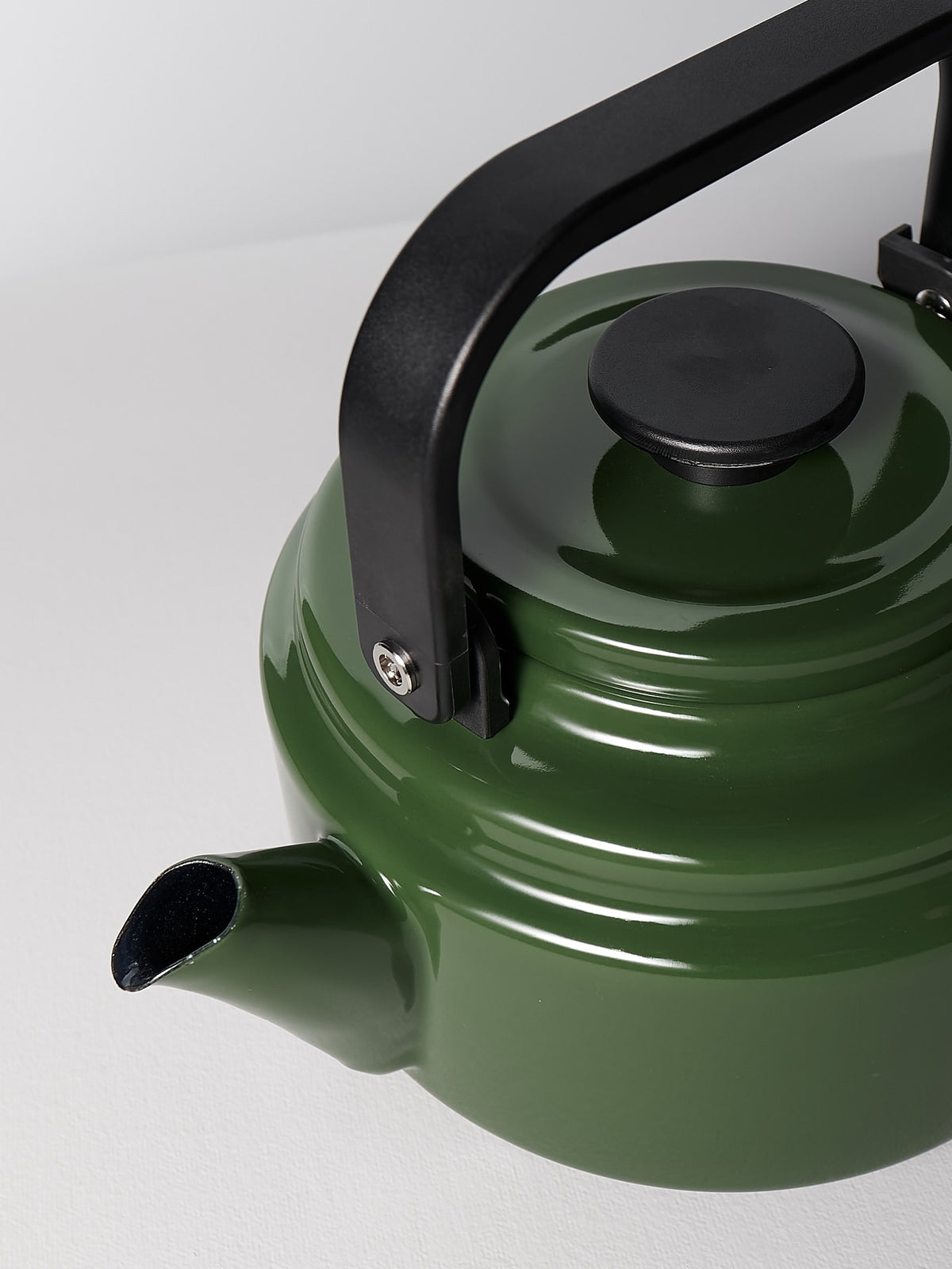An Amu Stove-top Kettle – Green by Noda Horo on a white surface.