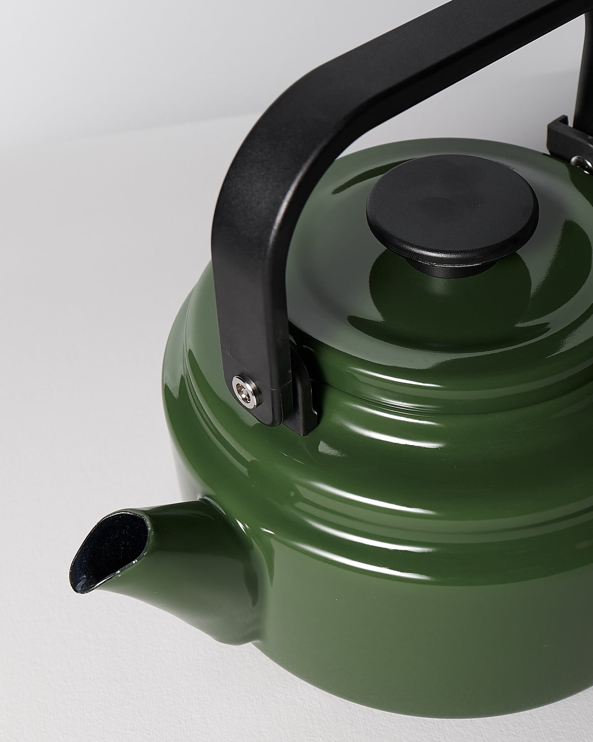 An Amu Stove-top Kettle – Green by Noda Horo on a white surface.