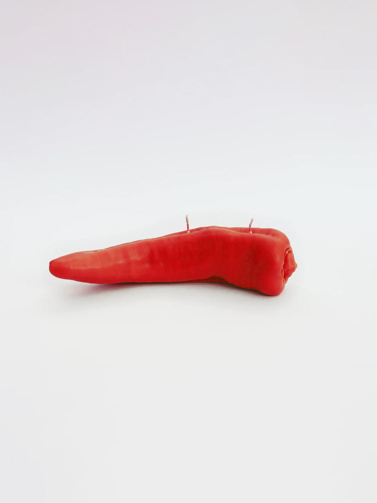 A Red Chilli Candle by Nonna&#39;s Grocer on a white background.