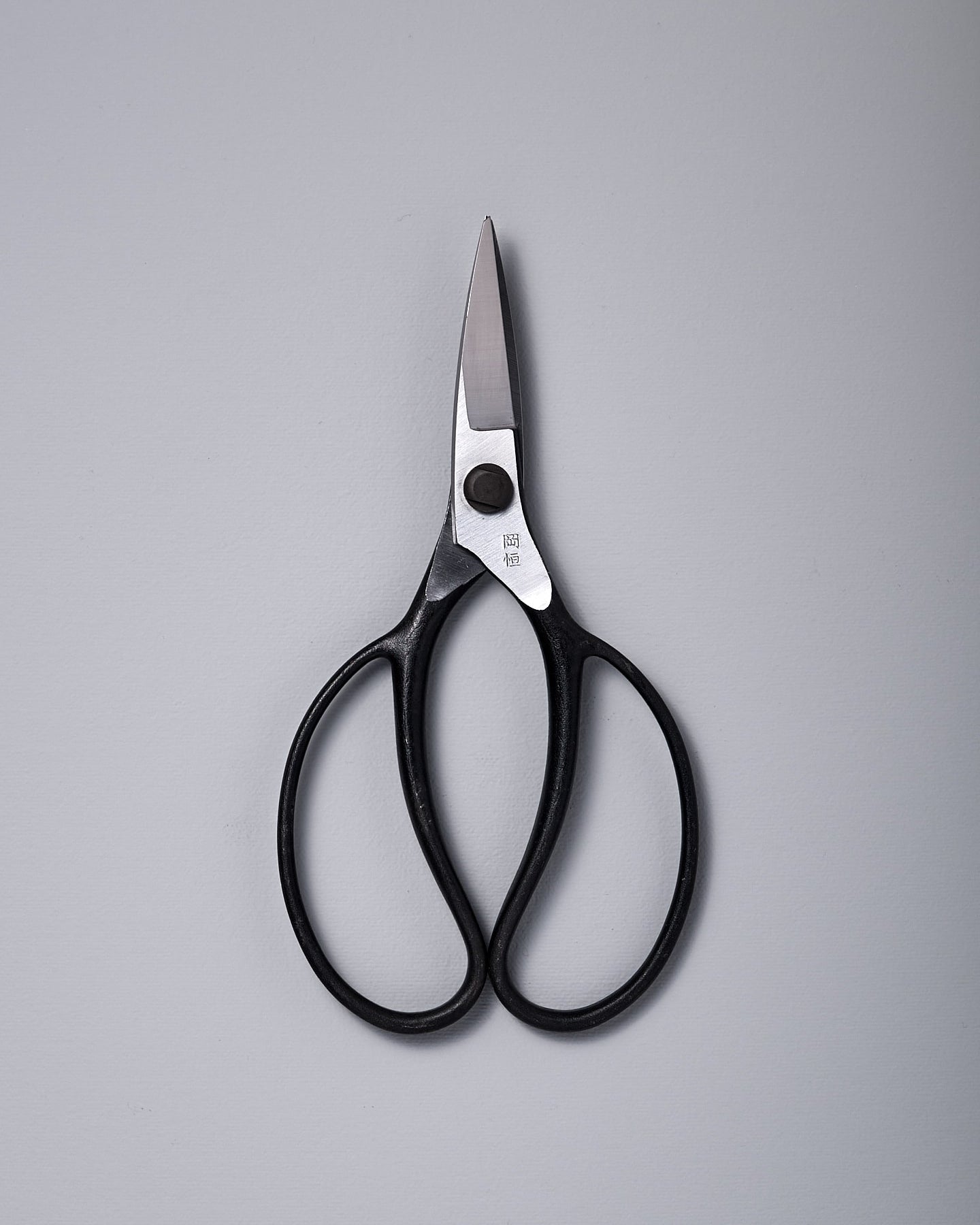 A pair of Okatsune Garden Scissors №221 – Small on a white surface.