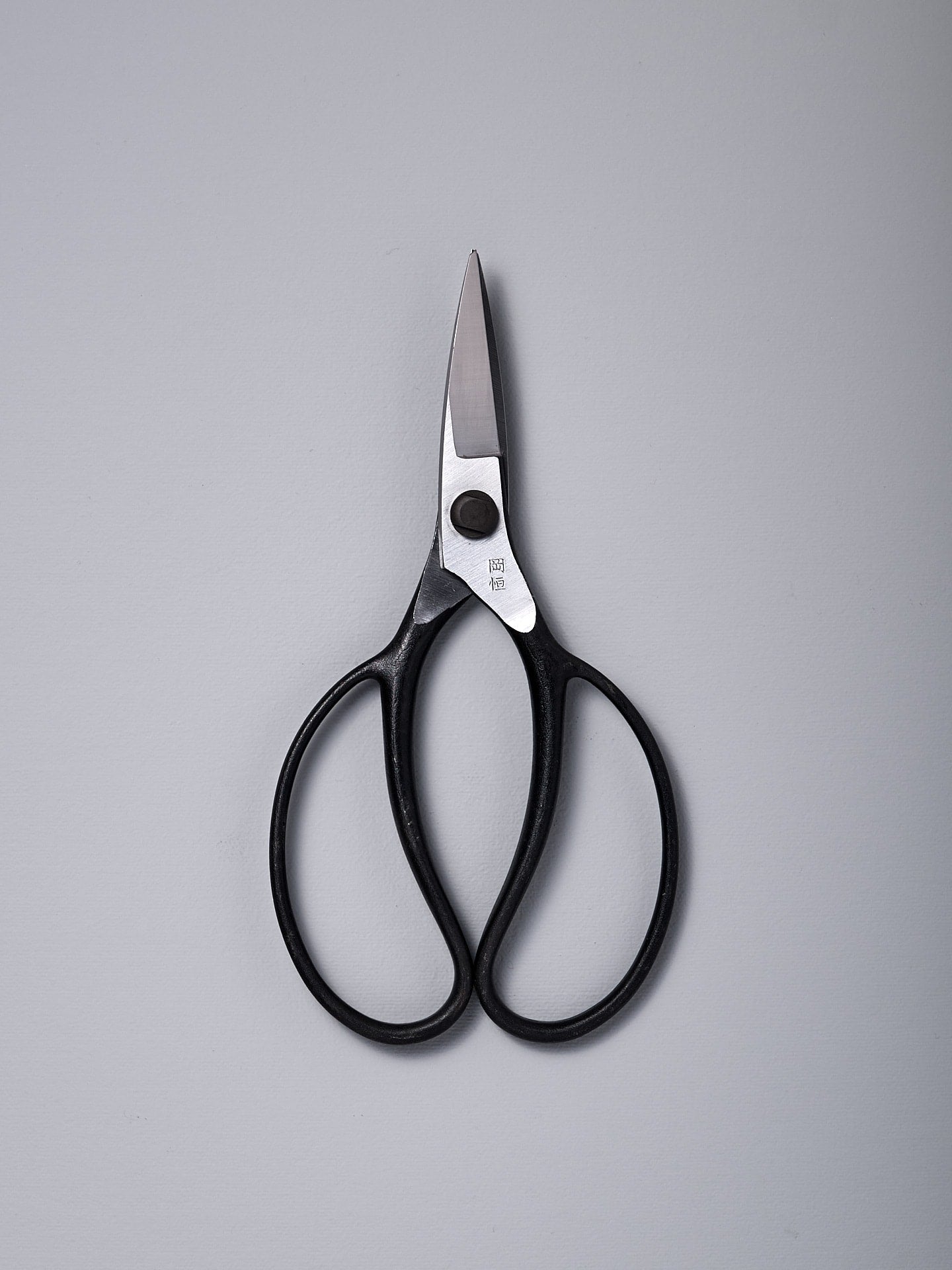 A pair of Okatsune Garden Scissors №221 – Small on a white surface.