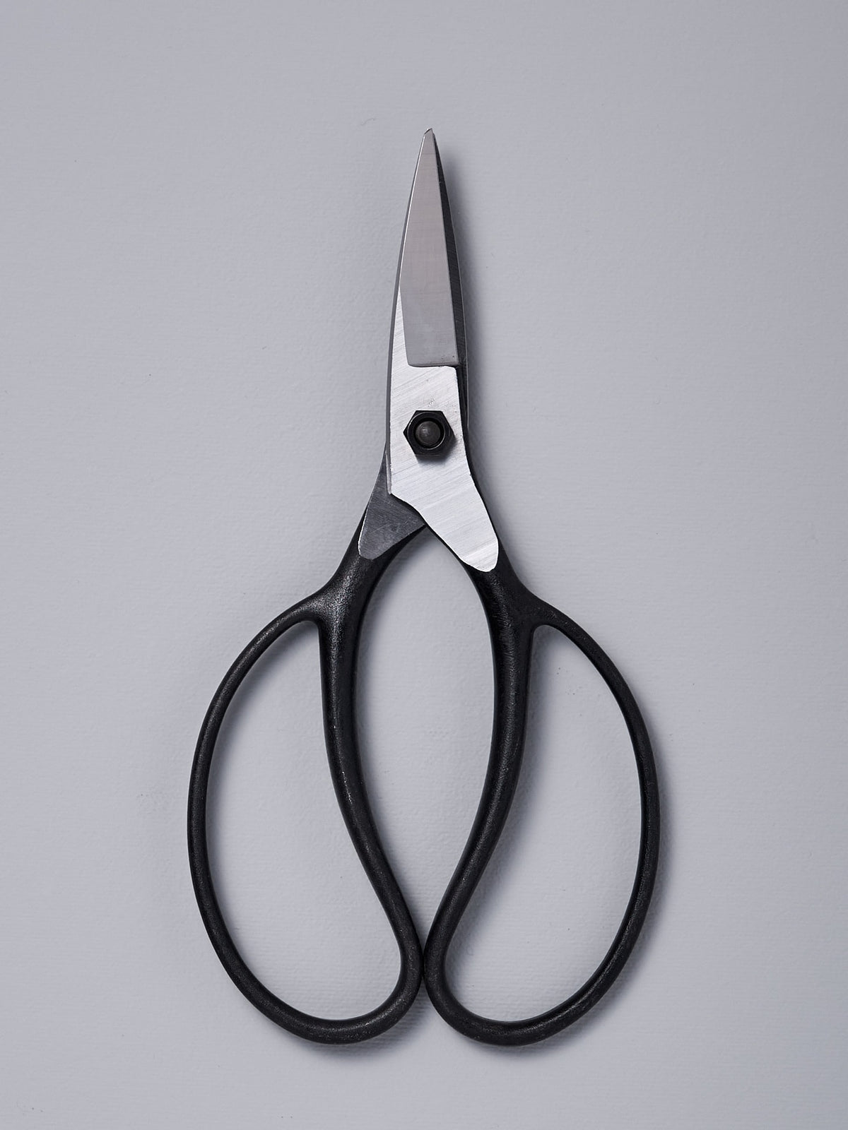 A pair of Okatsune Garden Scissors №221 – Small on a gray background.