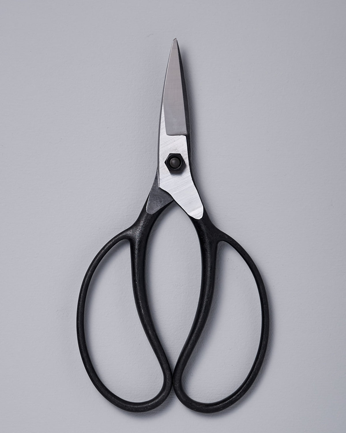 A pair of Okatsune Garden Scissors №221 – Small on a gray background.