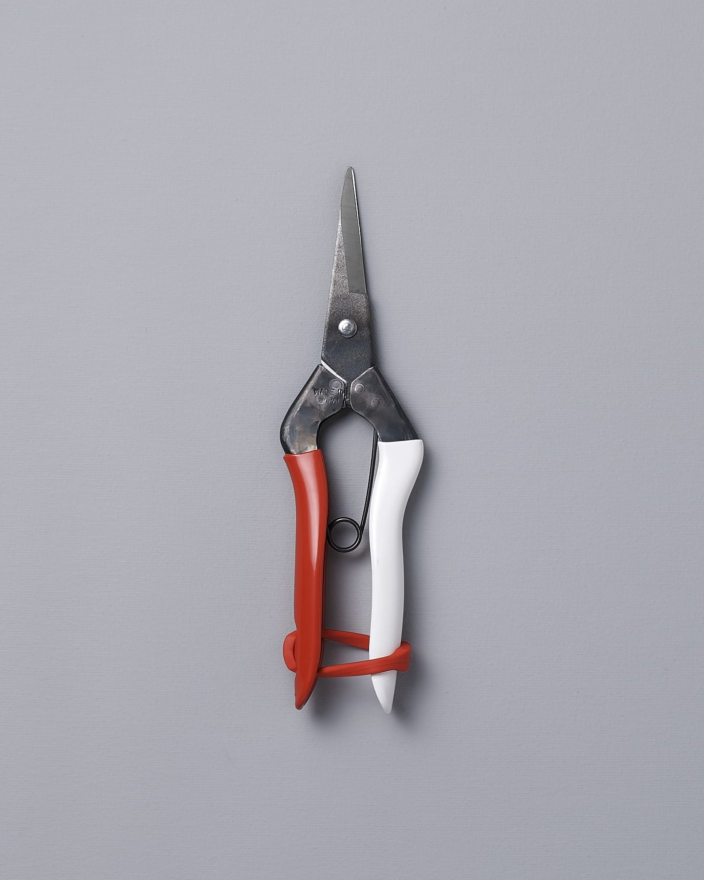 A pair of Okatsune Japanese Snips №304 on a gray background.